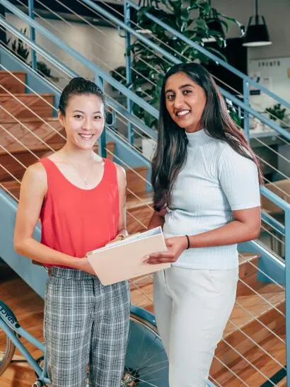 Two women smiling after task completion
